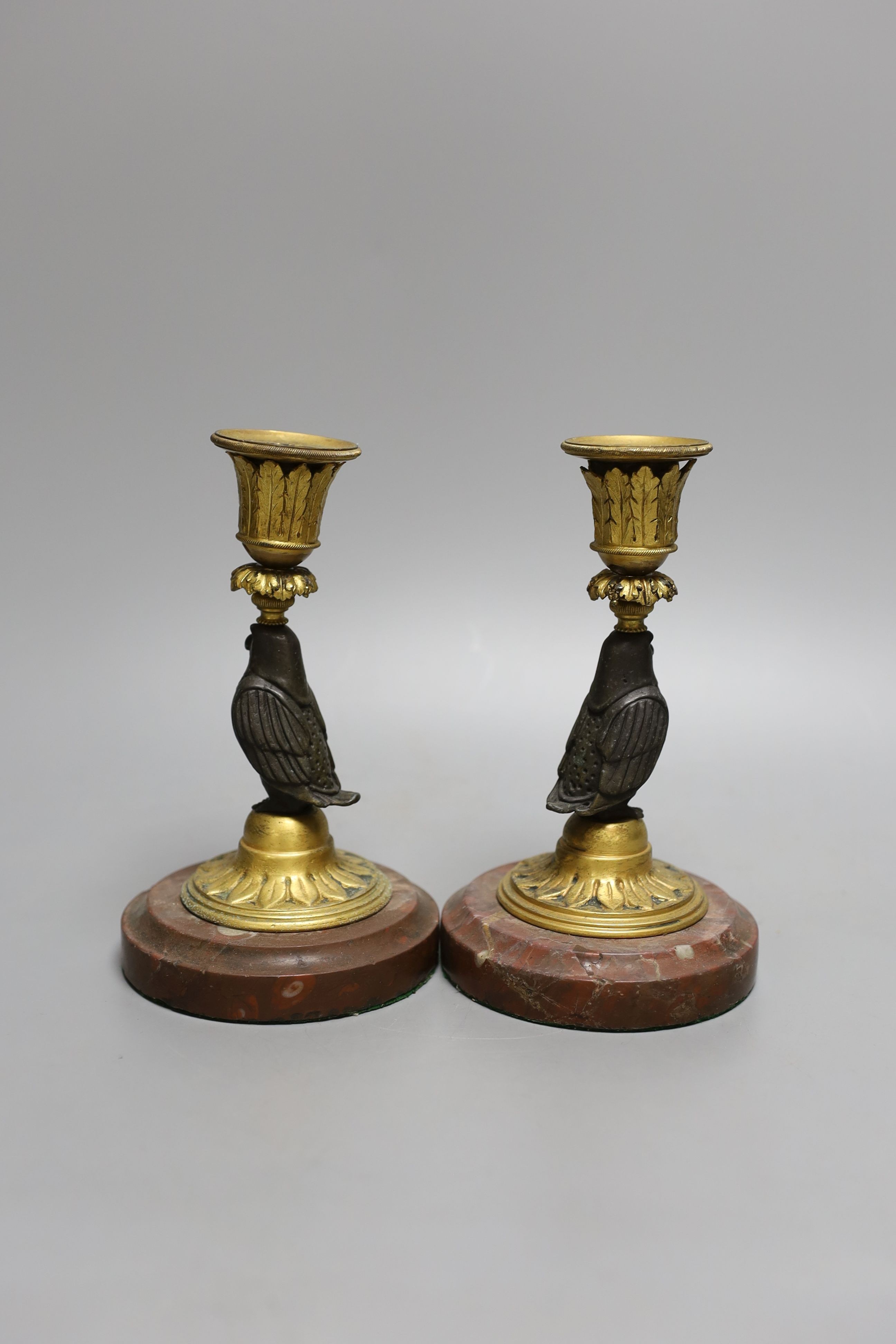 A pair of bronze and ormolu owl candlesticks - 16.5cm tall